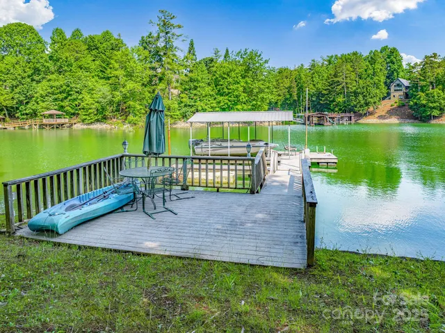 a view of a bench in the garden near a lake