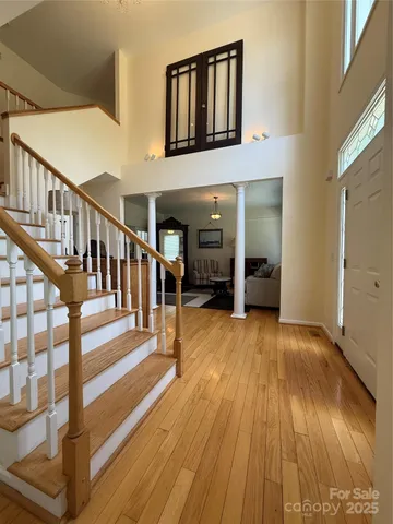 a view of an entryway with wooden floor