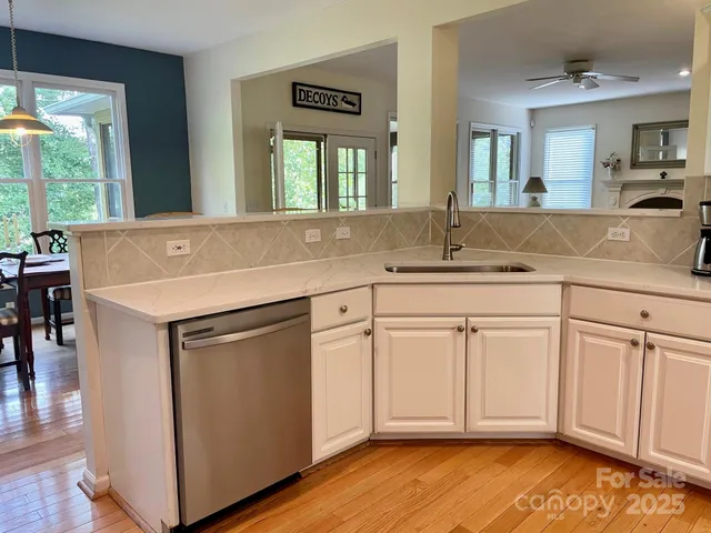 a kitchen with a sink cabinets and wooden floor