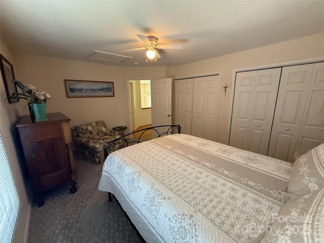 a bedroom with a large bed and a dresser