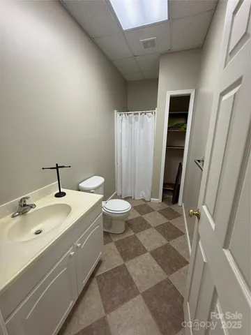 a spacious bathroom with a granite countertop sink toilet and shower