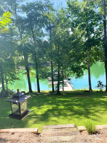 a view of yard with swimming pool and bench