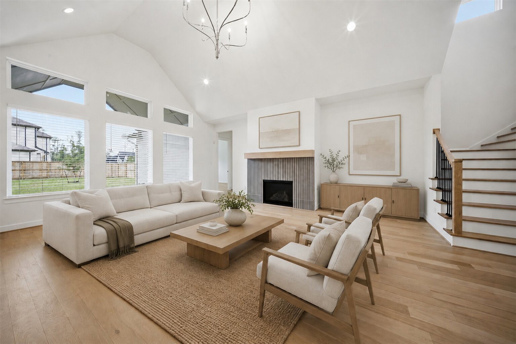 416 Venado View Court Conroe, TX 77304 - Photo 2 of 34 **Virtually Staged** Light-filled living room with soaring ceilings, oversized windows, designer fireplace detail, and an inviting open-concept layout.