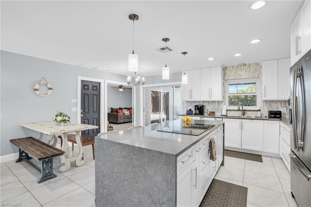 130 Mentor Drive Naples, FL 34110 - Photo 7 of 47 a kitchen with cabinets and window
