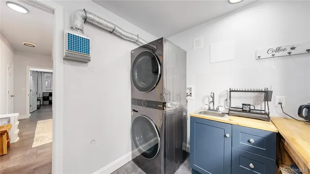 a utility room with sink dryer and washer