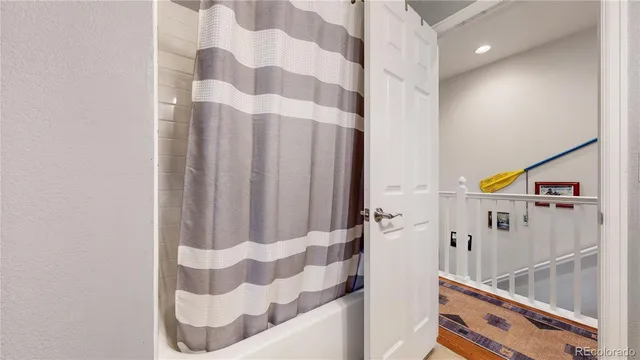 a bathroom with a bathtub and shower