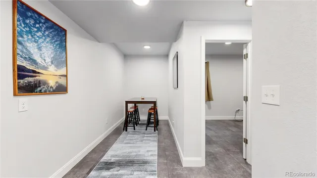 a view of a hallway with paintings on the wall