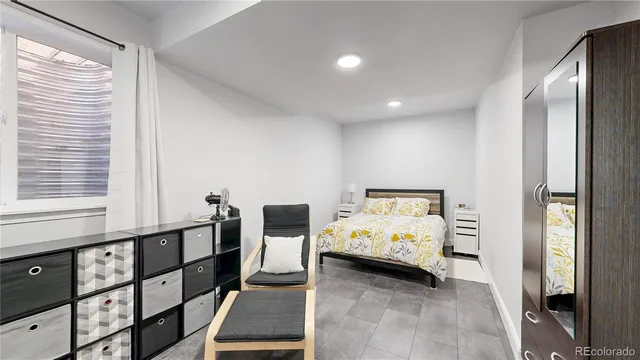 a bed room with furniture and window