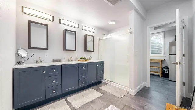 a spacious bathroom with a granite countertop sink mirror and shower