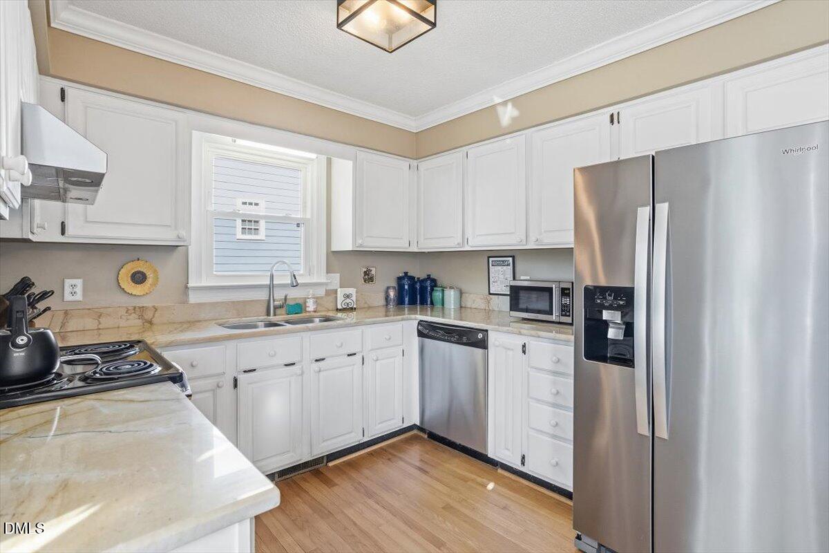 3516 East Jameson Road Raleigh, NC 27604 - Photo 11 of 32 a kitchen with stainless steel appliances granite countertop a refrigerator sink and stove