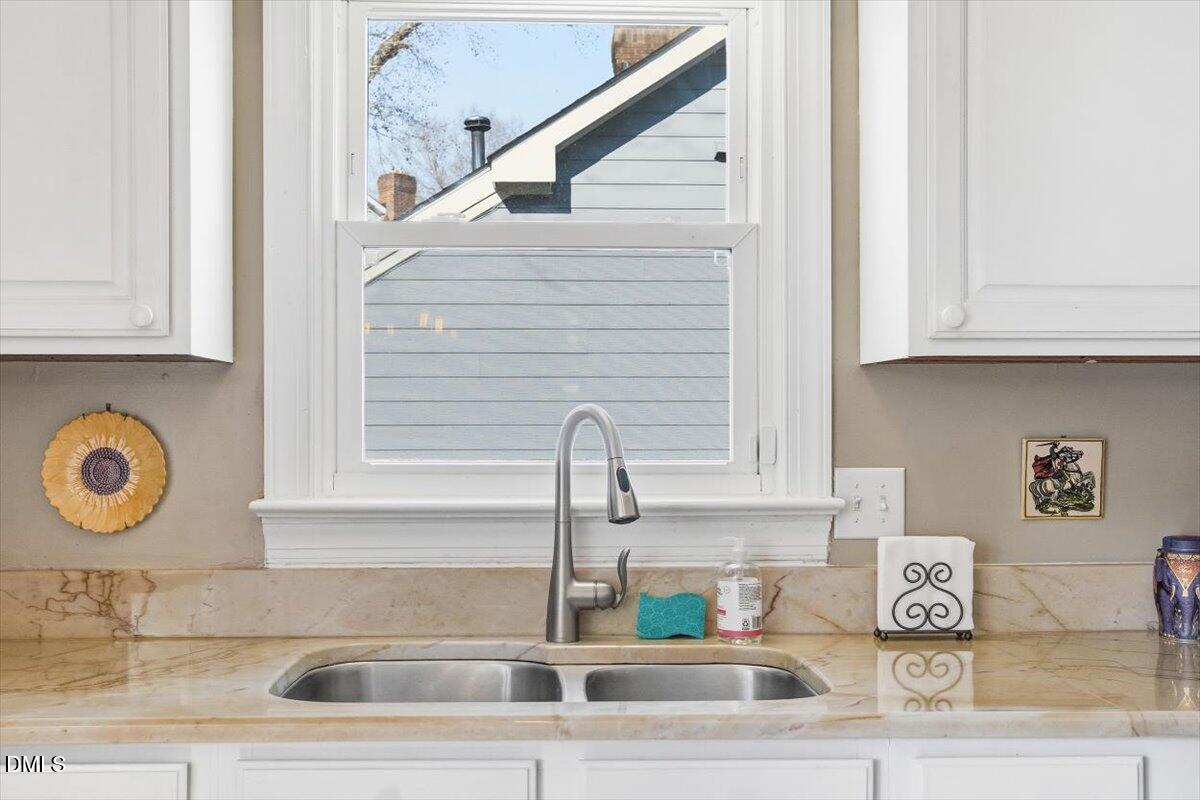 3516 East Jameson Road Raleigh, NC 27604 - Photo 12 of 32 a kitchen with a sink and cabinets