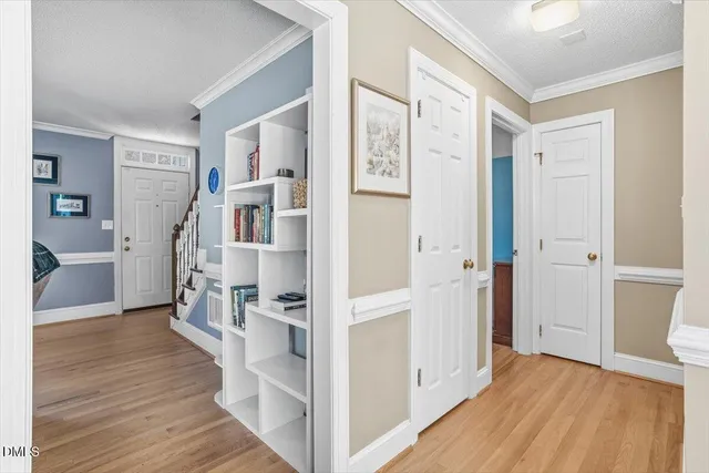 a view of entryway with wooden floor and a cabinet