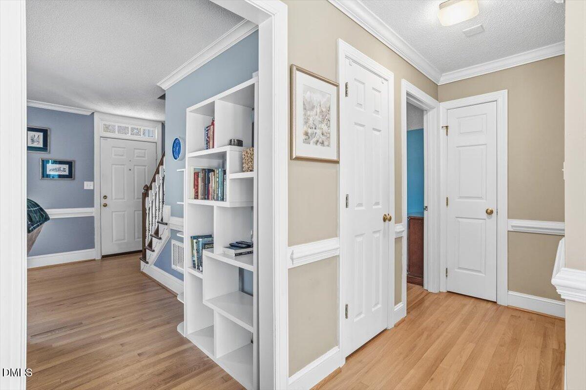 3516 East Jameson Road Raleigh, NC 27604 - Photo 14 of 32 a view of entryway with wooden floor and a cabinet