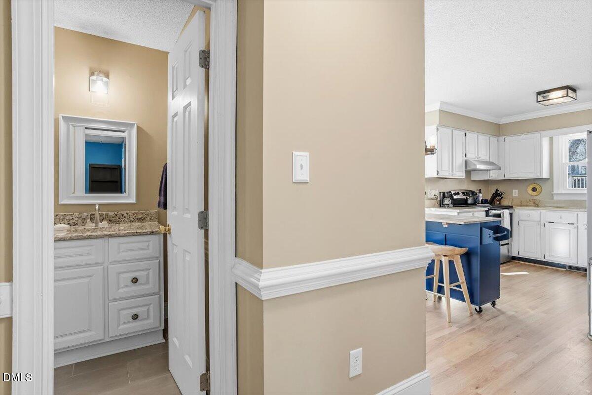 3516 East Jameson Road Raleigh, NC 27604 - Photo 15 of 32 a kitchen with cabinets and wooden floor