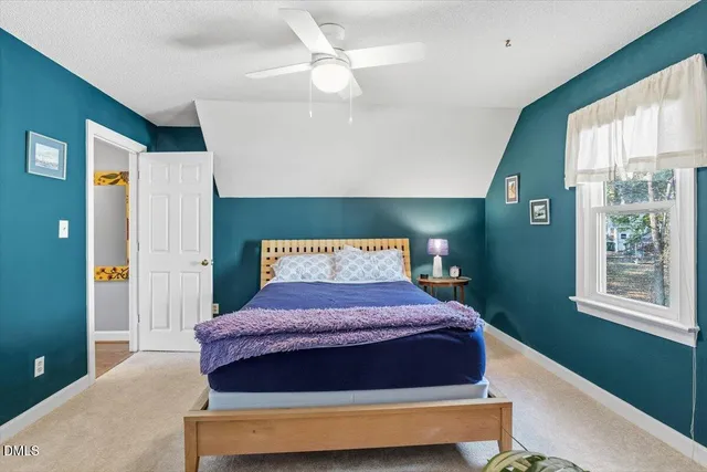 a bedroom with a large bed and a window