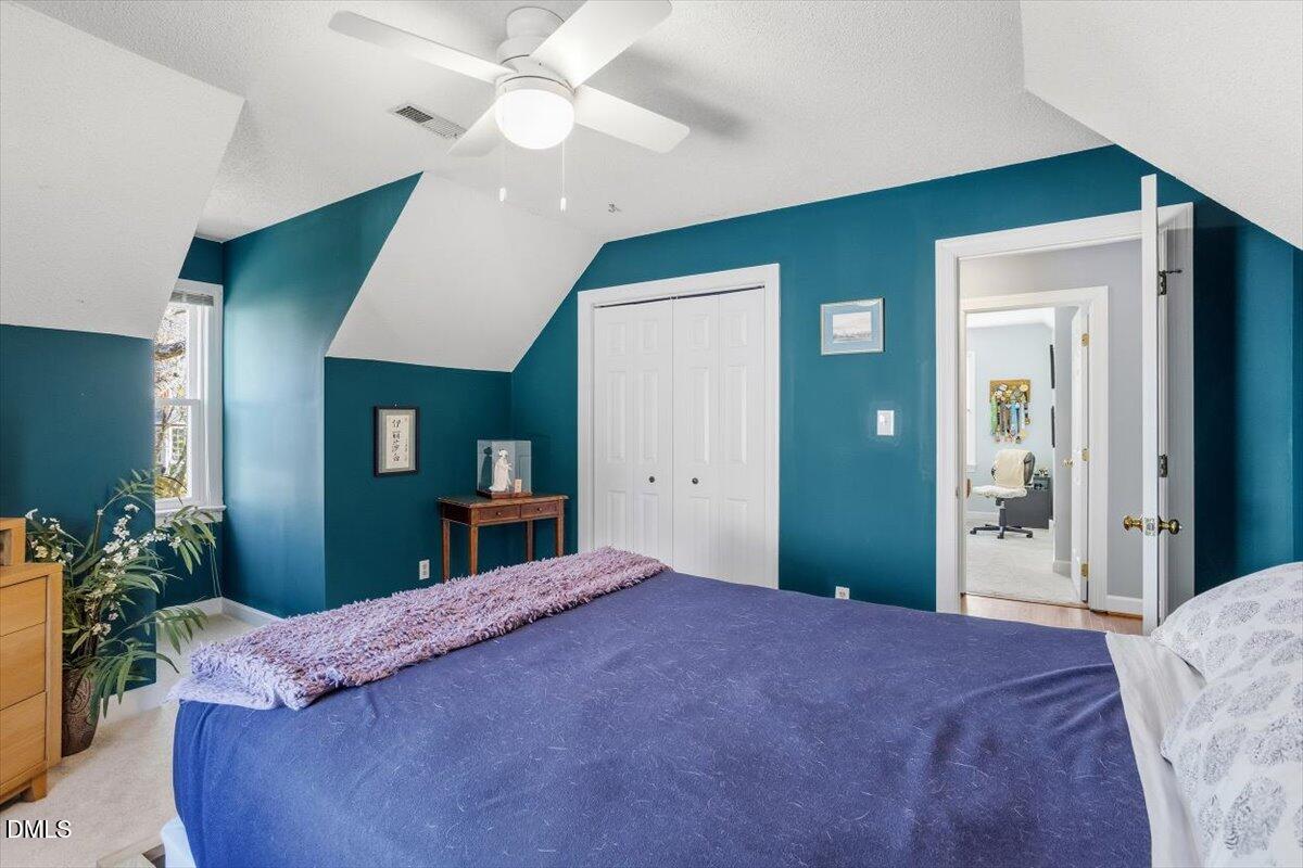 3516 East Jameson Road Raleigh, NC 27604 - Photo 23 of 32 a bedroom with a bed and a chandelier