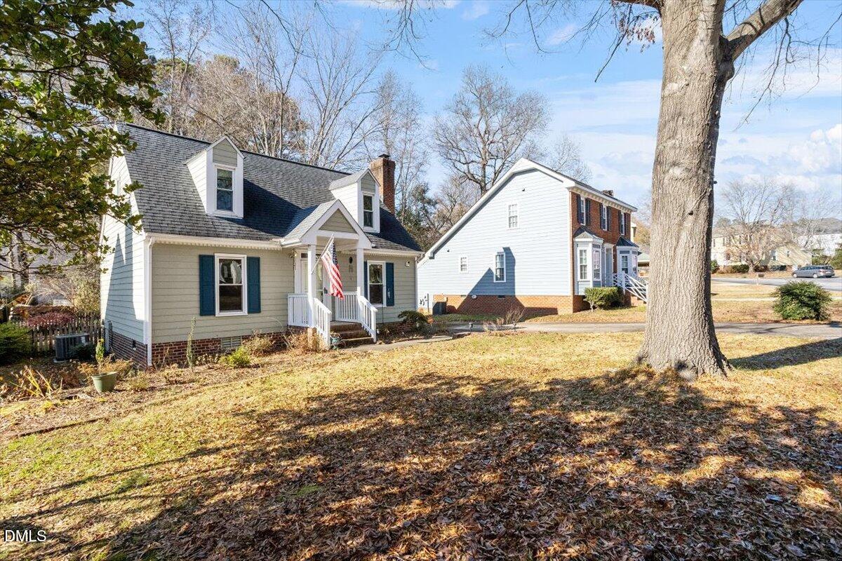 3516 East Jameson Road Raleigh, NC 27604 - Photo 3 of 32 a view of a white house next to a yard with a tree