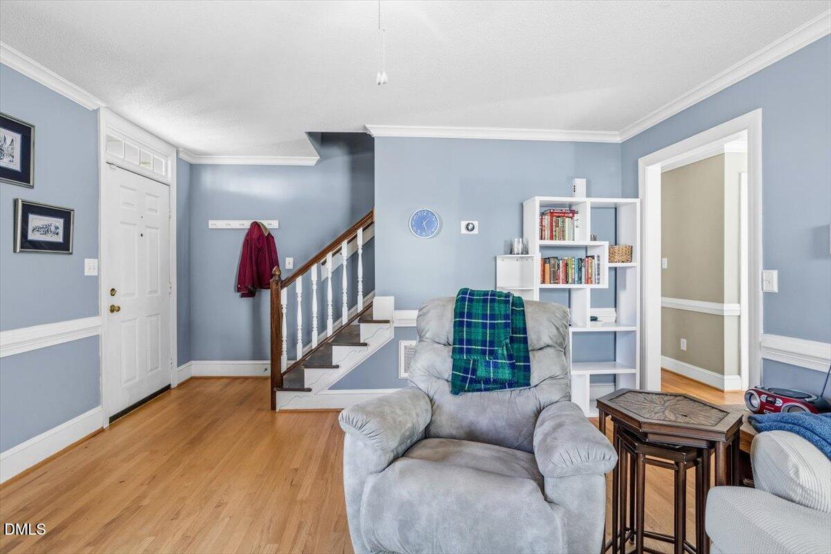 3516 East Jameson Road Raleigh, NC 27604 - Photo 6 of 32 a living room with furniture and a book shelf