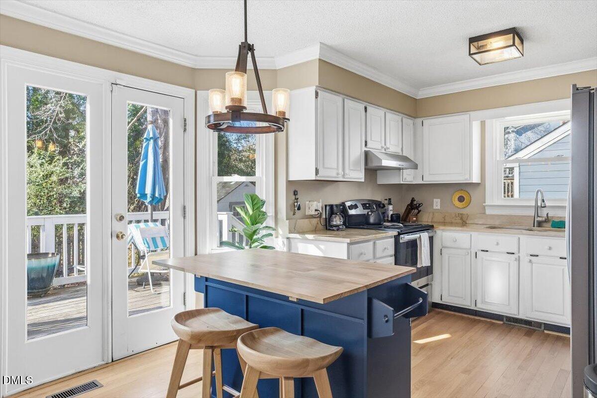 3516 East Jameson Road Raleigh, NC 27604 - Photo 9 of 32 a kitchen with granite countertop a stove a sink and a refrigerator