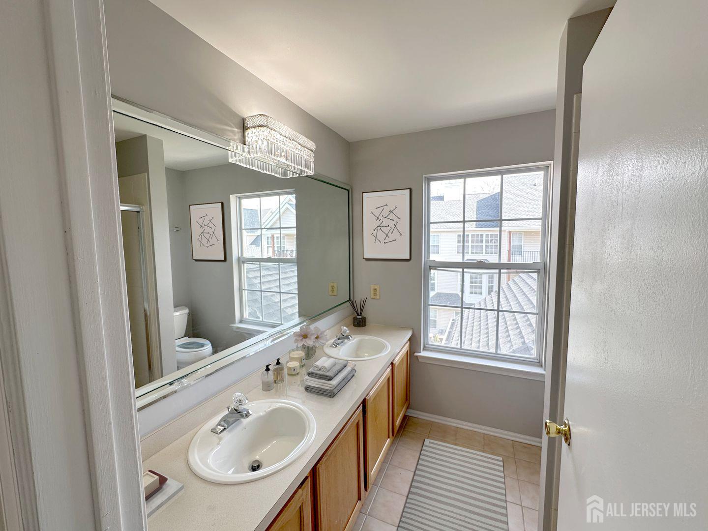 1212 Plymouth Road North Brunswick, NJ 08902 - Photo 24 of 27 a en suite bathroom with a sink mirror and a bathtub