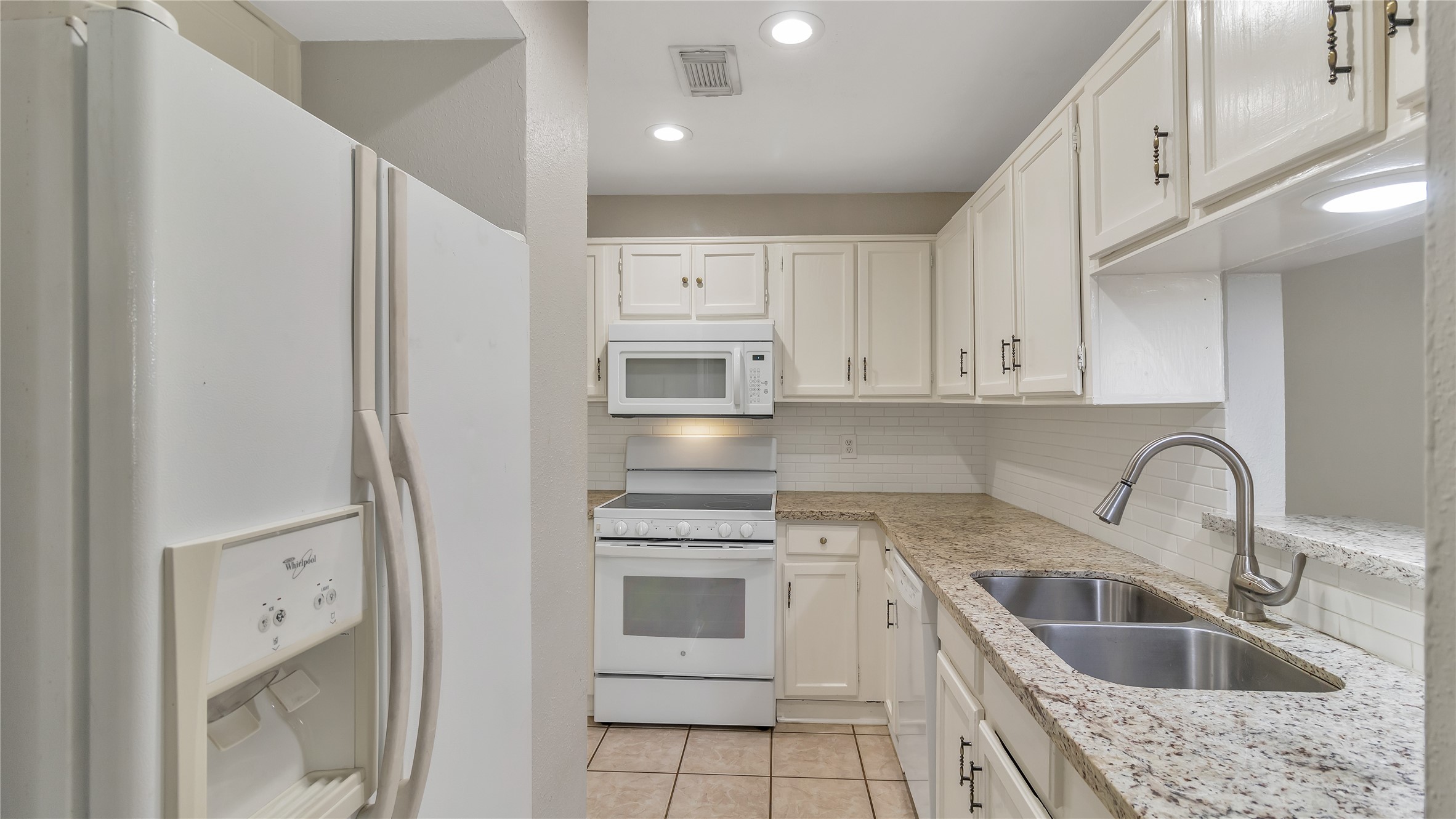 4505 Terrace Manor Drive Houston, TX 77041 - Photo 12 of 19 a kitchen with stainless steel appliances granite countertop a sink stove and refrigerator