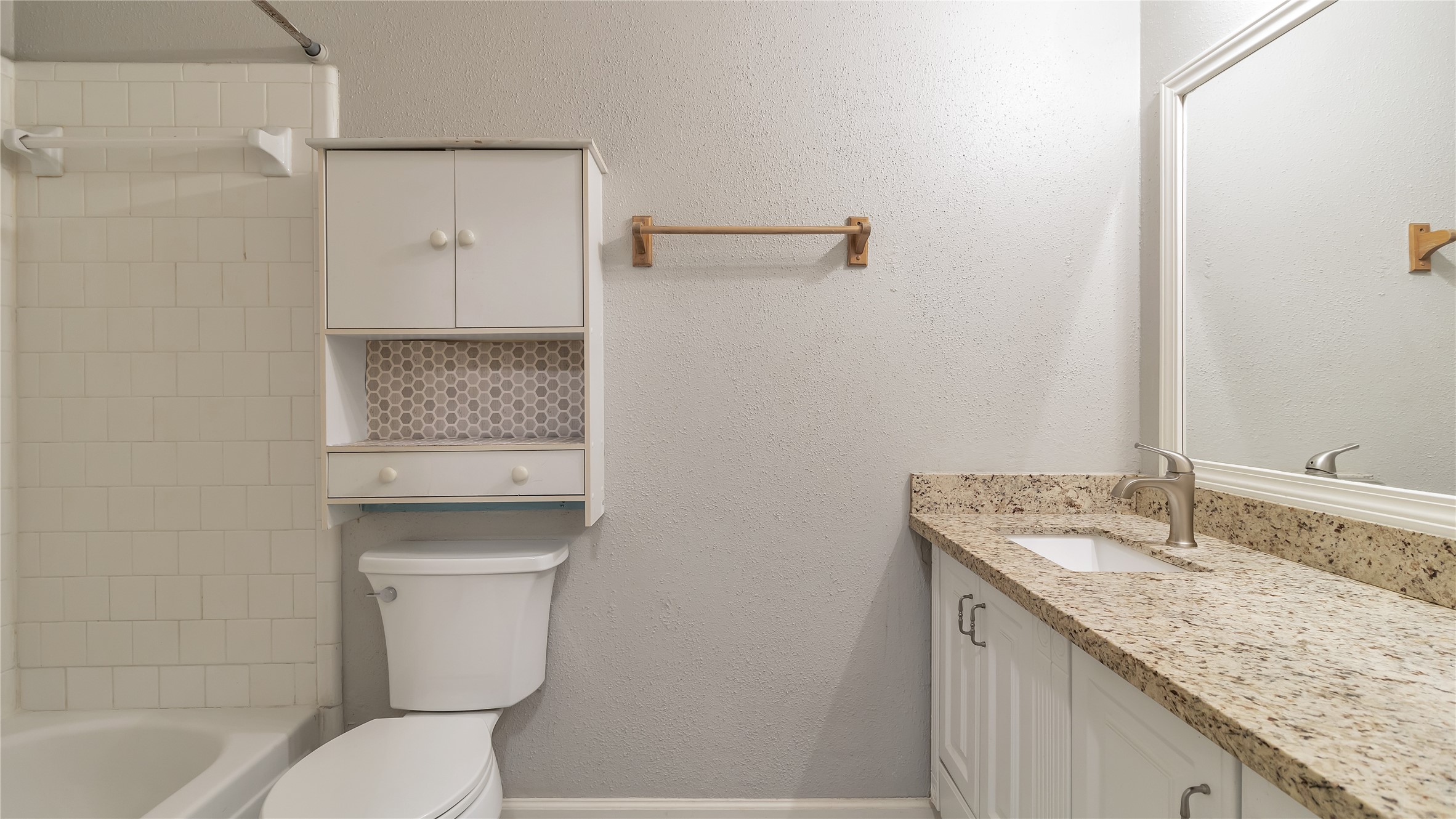 4505 Terrace Manor Drive Houston, TX 77041 - Photo 14 of 19 a bathroom with a granite countertop sink a toilet and shower