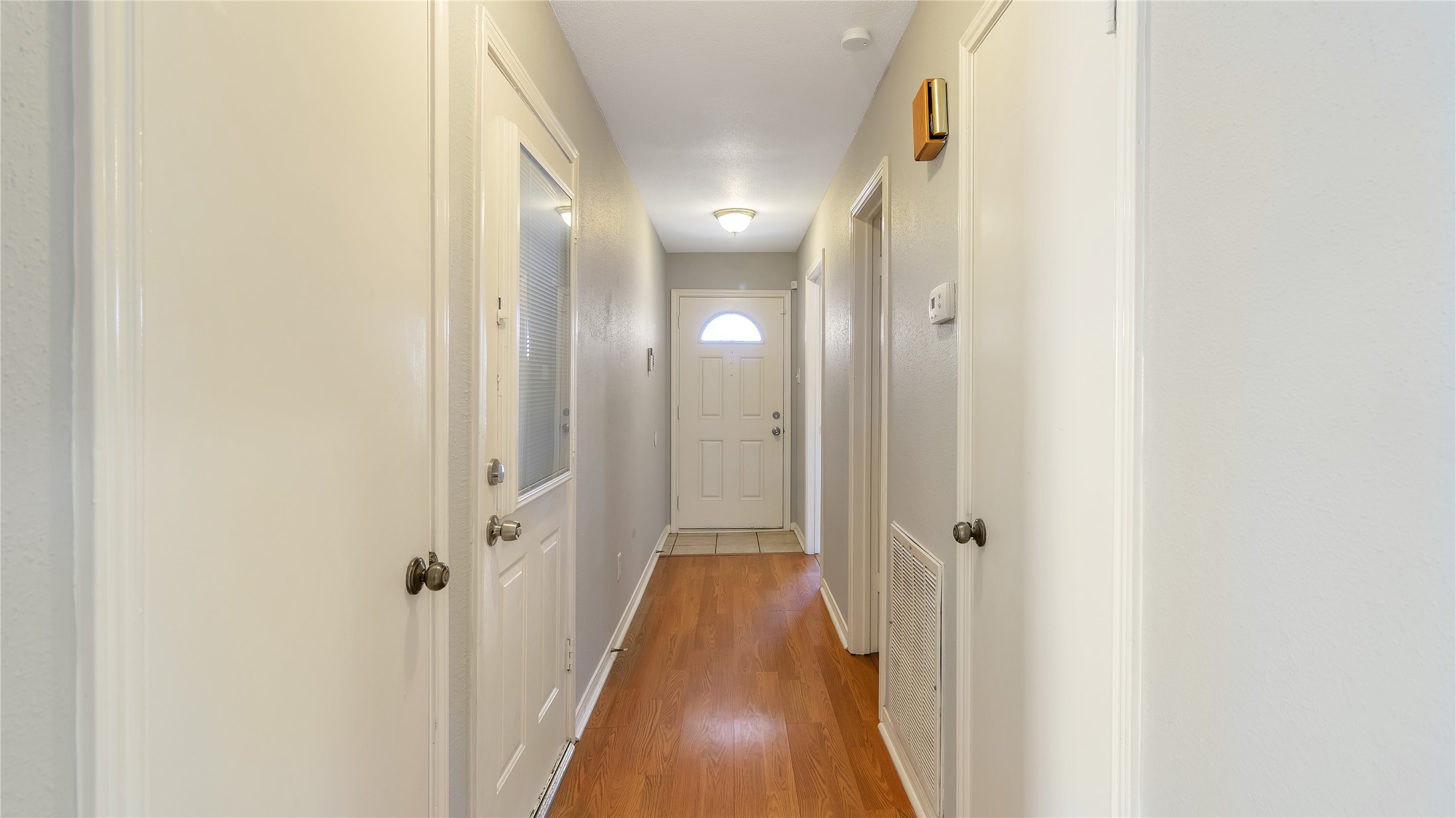 4505 Terrace Manor Drive Houston, TX 77041 - Photo 2 of 19 a view of a hallway with wooden floor and a bathroom