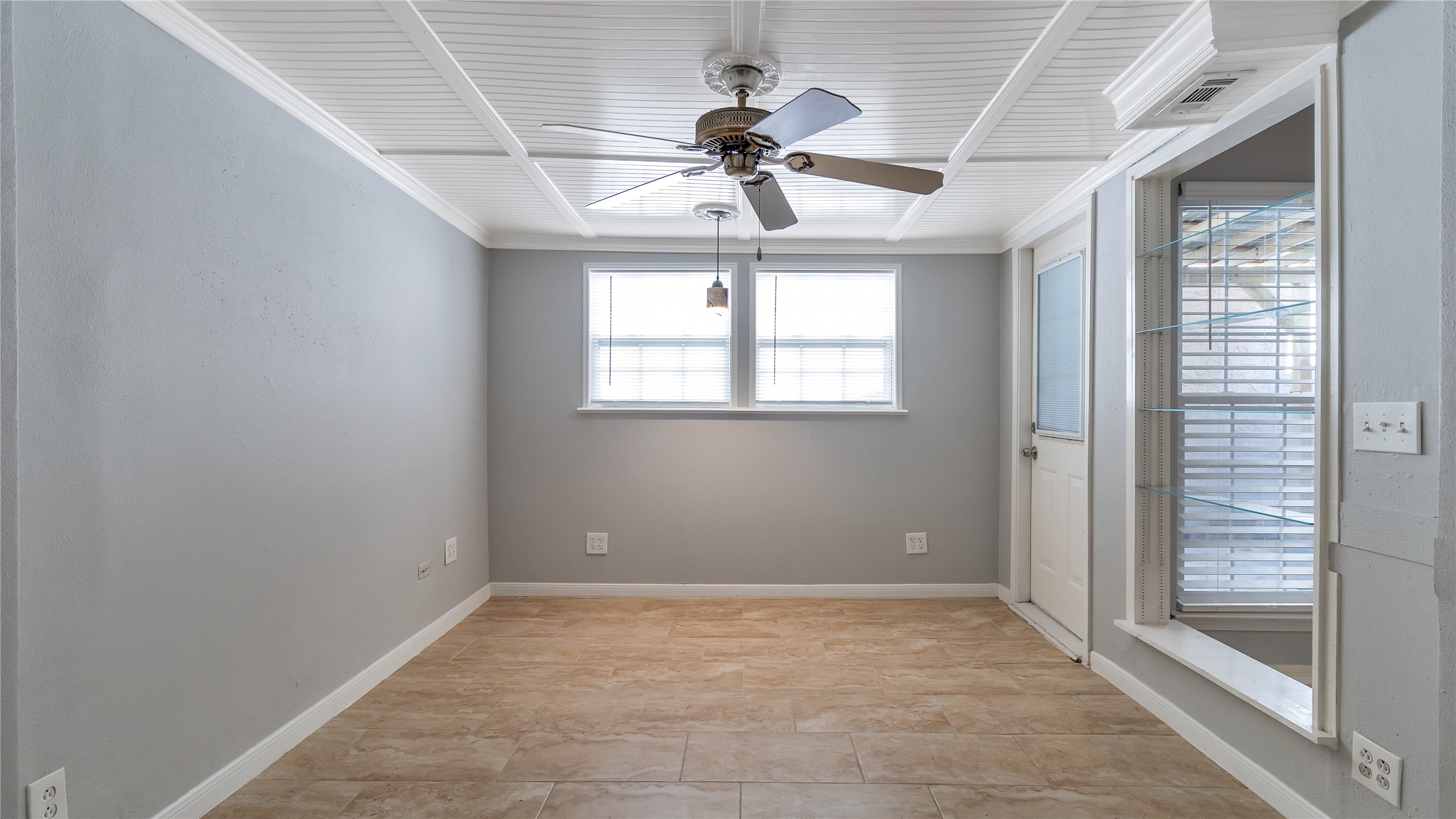 4505 Terrace Manor Drive Houston, TX 77041 - Photo 9 of 19 an empty room with a chandelier fan and windows