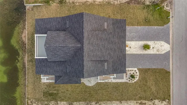 a view of staircase with lots of frames on wall and wooden floor