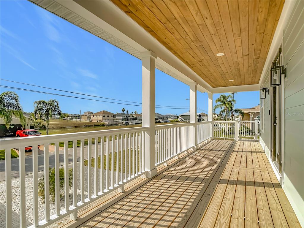 3487 Sheephead Drive Hernando Beach, FL 34607 - Photo 17 of 77 a view of a balcony with wooden floor and outdoor seating
