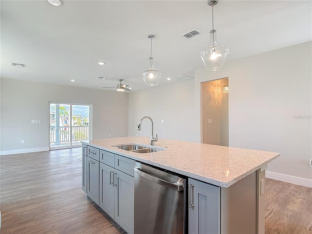 3487 Sheephead Drive Hernando Beach, FL 34607 - Photo 40 of 77 a kitchen with a sink a counter space and wooden floor