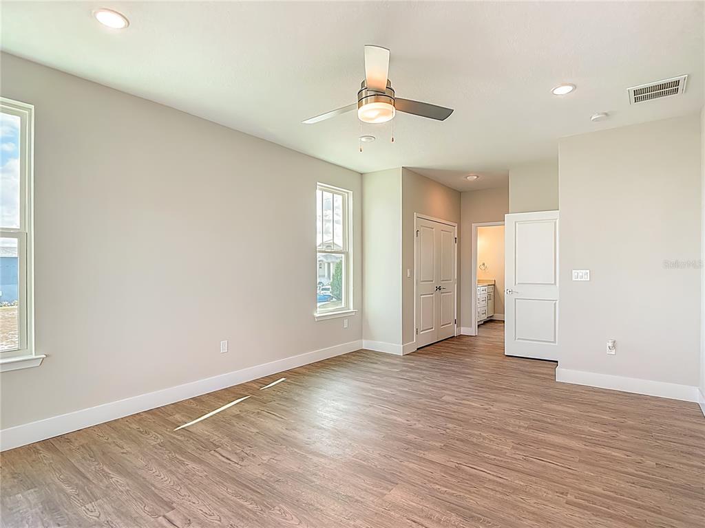 3487 Sheephead Drive Hernando Beach, FL 34607 - Photo 53 of 77 an empty room with wooden floor and windows