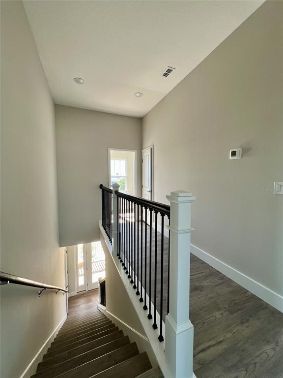 3487 Sheephead Drive Hernando Beach, FL 34607 - Photo 64 of 77 a view of a hallway with wooden floor and staircase