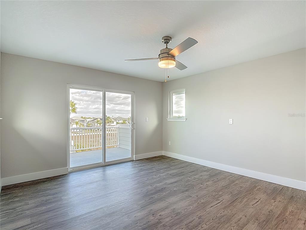 3487 Sheephead Drive Hernando Beach, FL 34607 - Photo 66 of 77 an empty room with wooden floor and windows