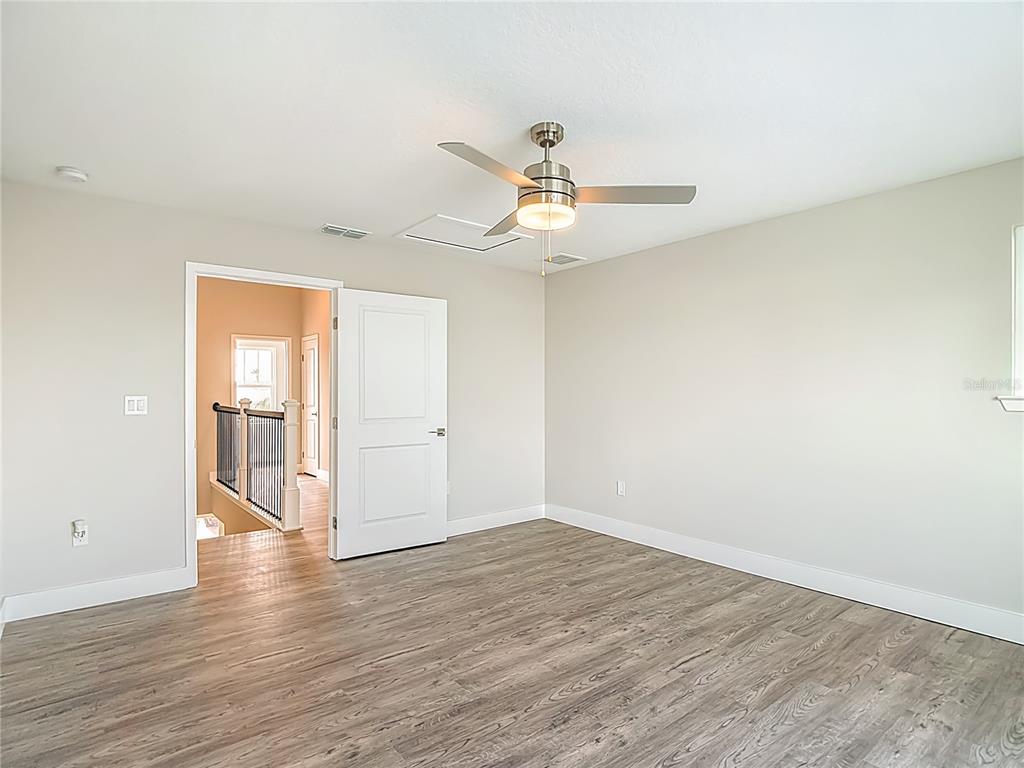 3487 Sheephead Drive Hernando Beach, FL 34607 - Photo 68 of 77 a view of an empty room with wooden floor and a window