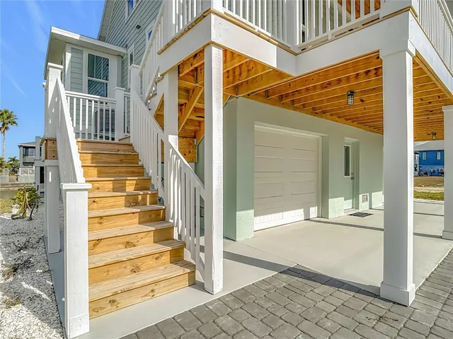 a view of a balcony with wooden floor and outdoor seating