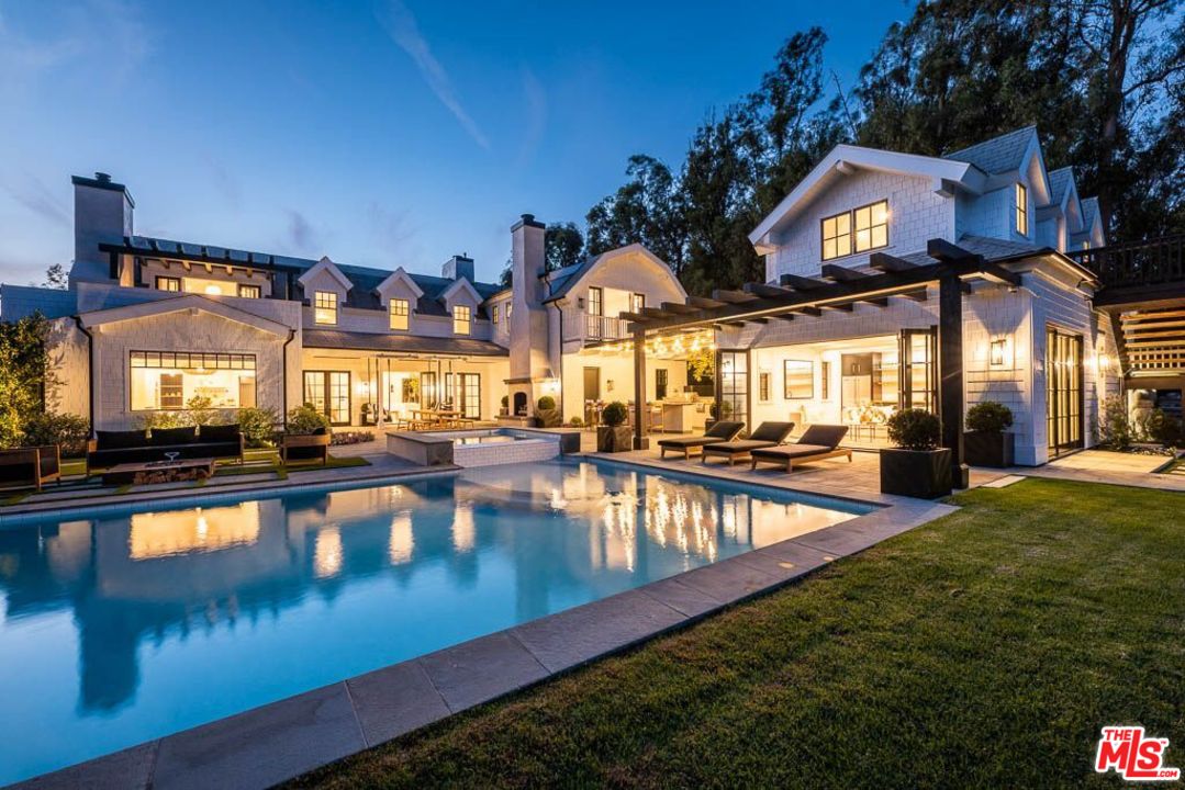 a view of a swimming pool with outdoor seating