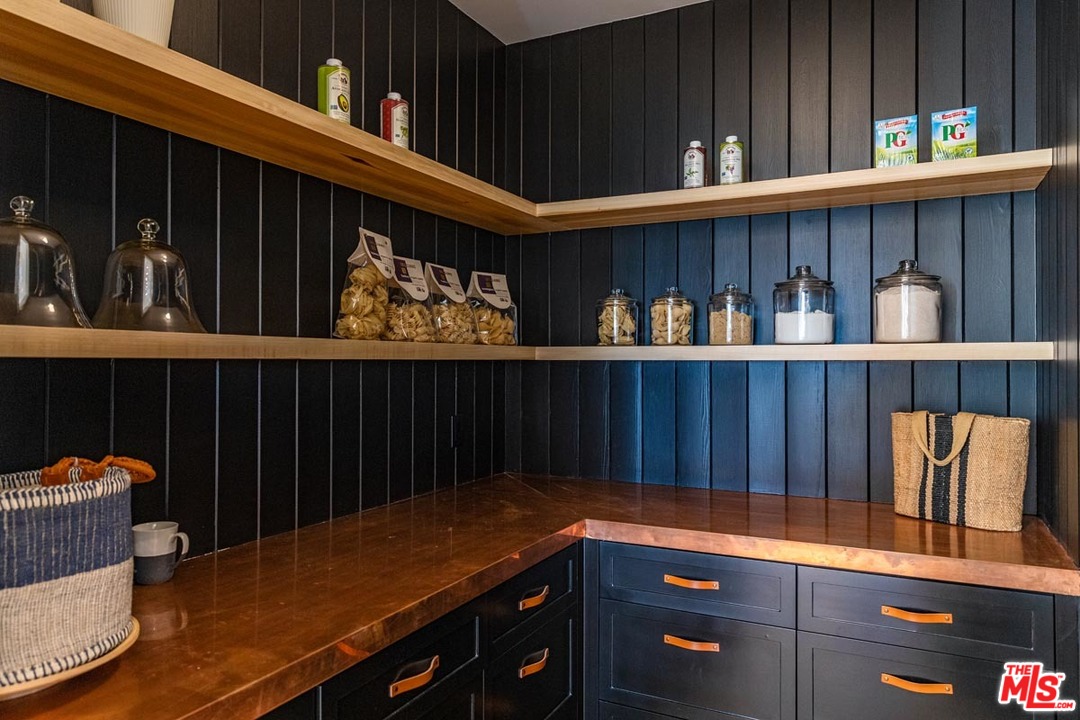 6950 Dume Drive Malibu, CA 90265 - Photo 11 of 24 a kitchen with a refrigerator and wooden cabinets