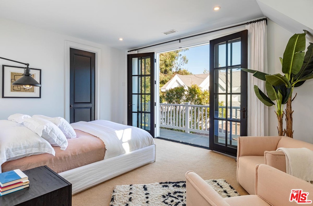 6950 Dume Drive Malibu, CA 90265 - Photo 14 of 24 a bedroom with furniture and a large window