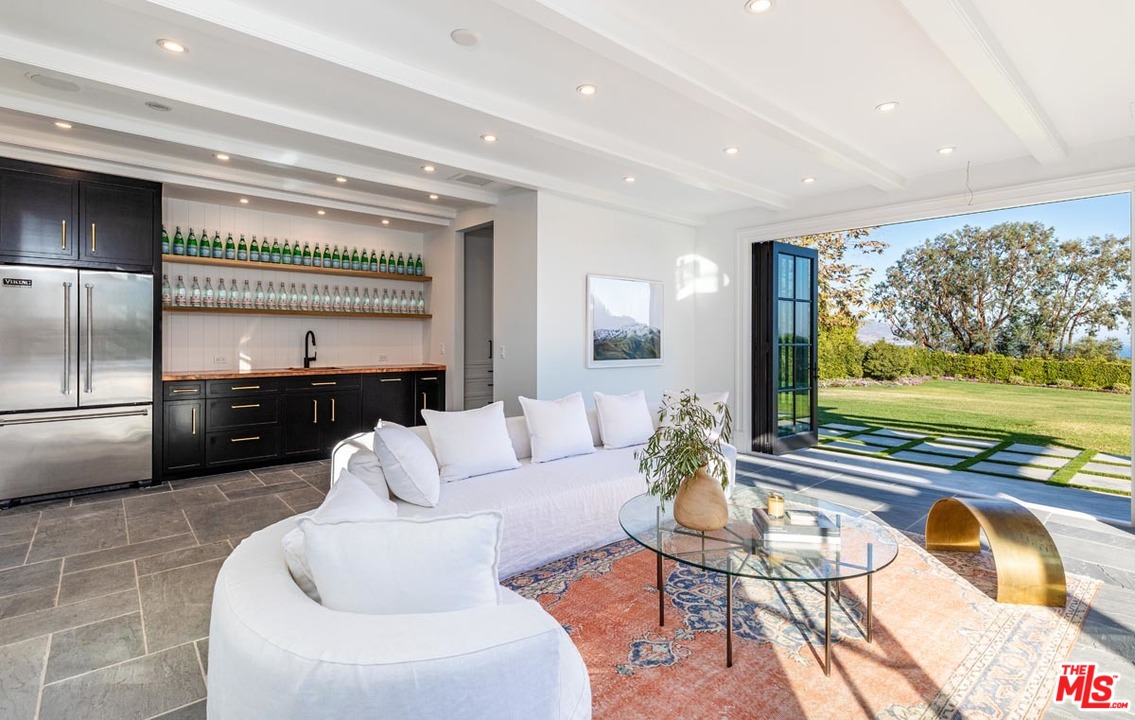6950 Dume Drive Malibu, CA 90265 - Photo 18 of 24 a living room with furniture and a flat screen tv