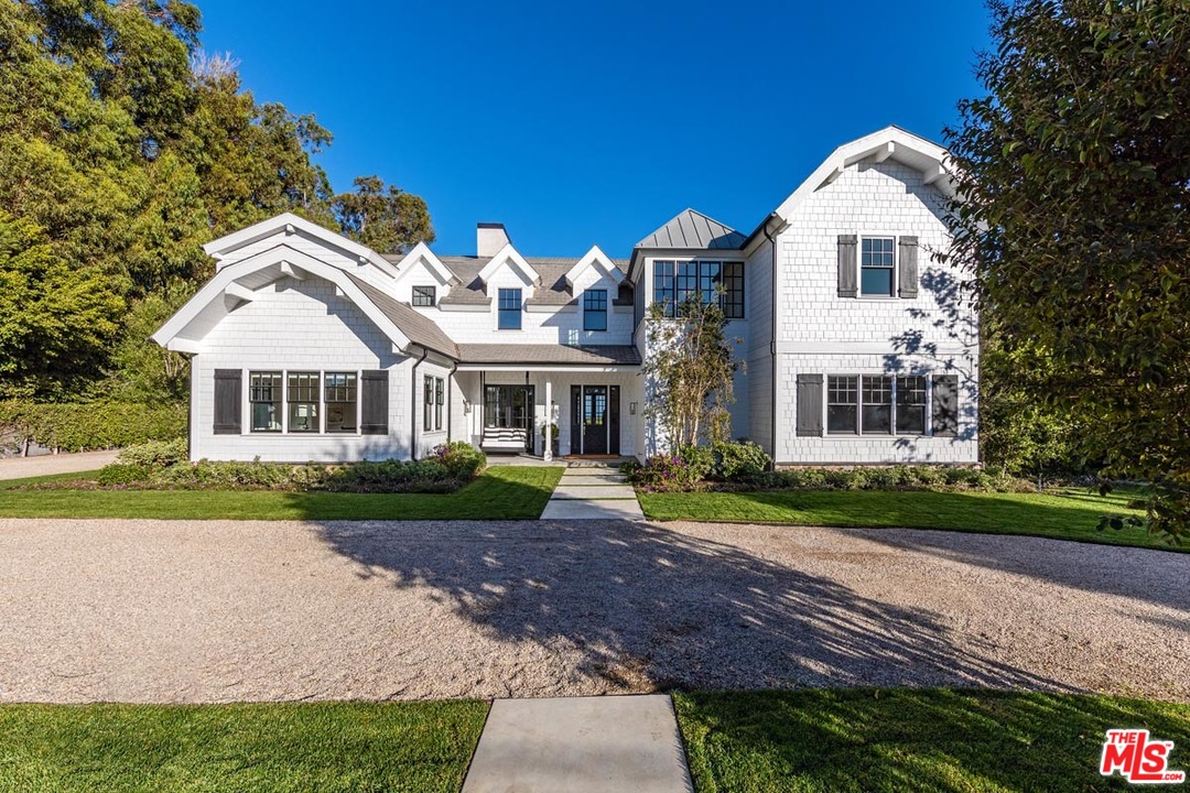 6950 Dume Drive Malibu, CA 90265 - Photo 24 of 24 a front view of a house with a yard