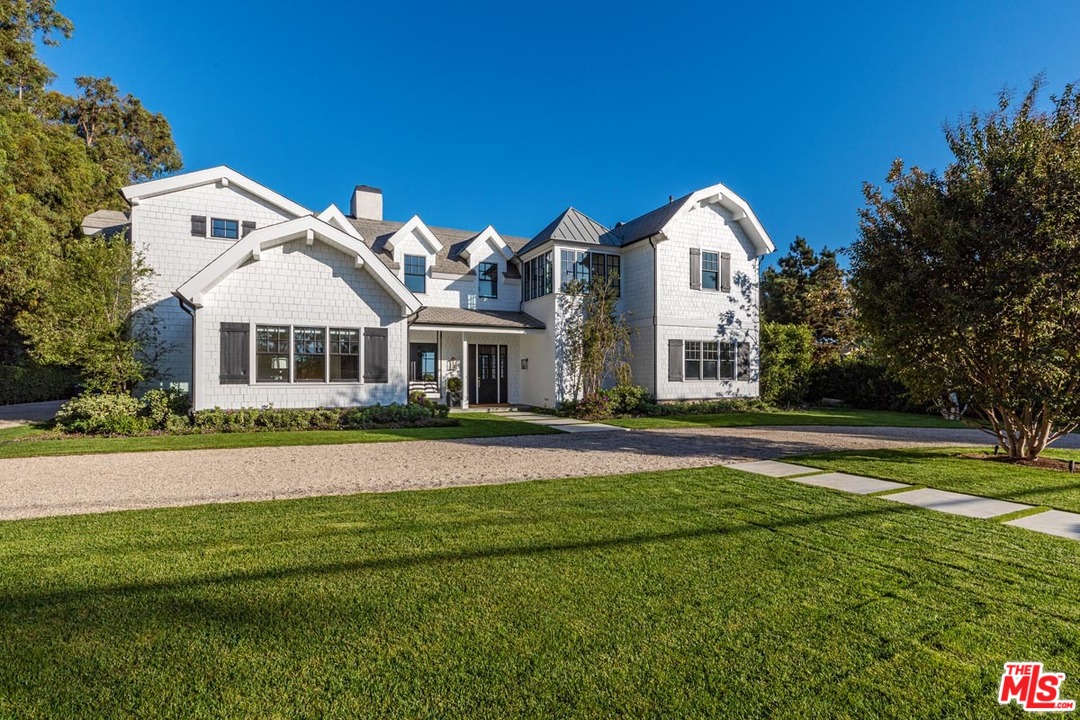 6950 Dume Drive Malibu, CA 90265 - Photo 4 of 24 a front view of a house with a yard