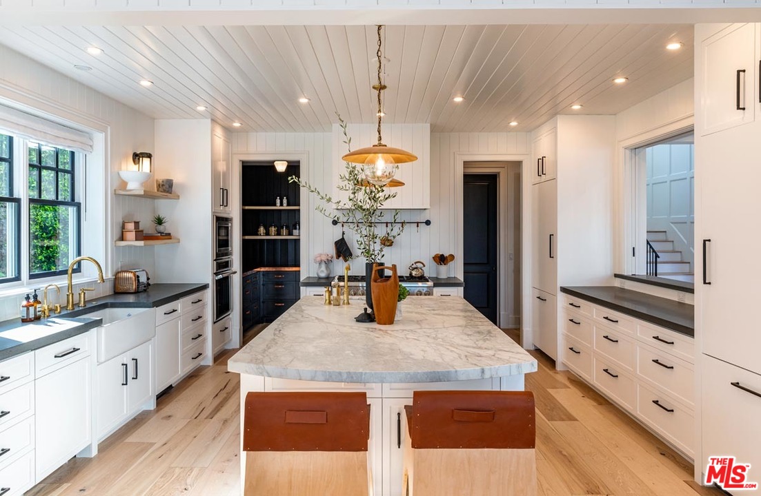 6950 Dume Drive Malibu, CA 90265 - Photo 9 of 24 a kitchen with stainless steel appliances kitchen island granite countertop a stove and cabinets