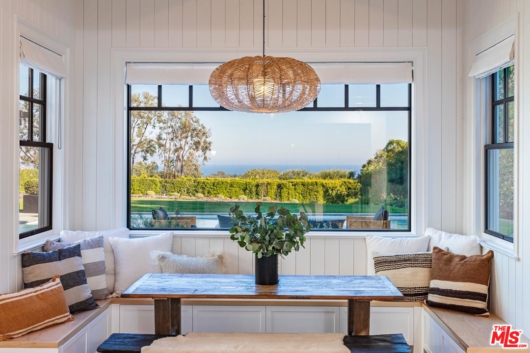 6950 Dume Drive Malibu, CA 90265 - Photo 10 of 24 a living room with fireplace furniture and a potted plant