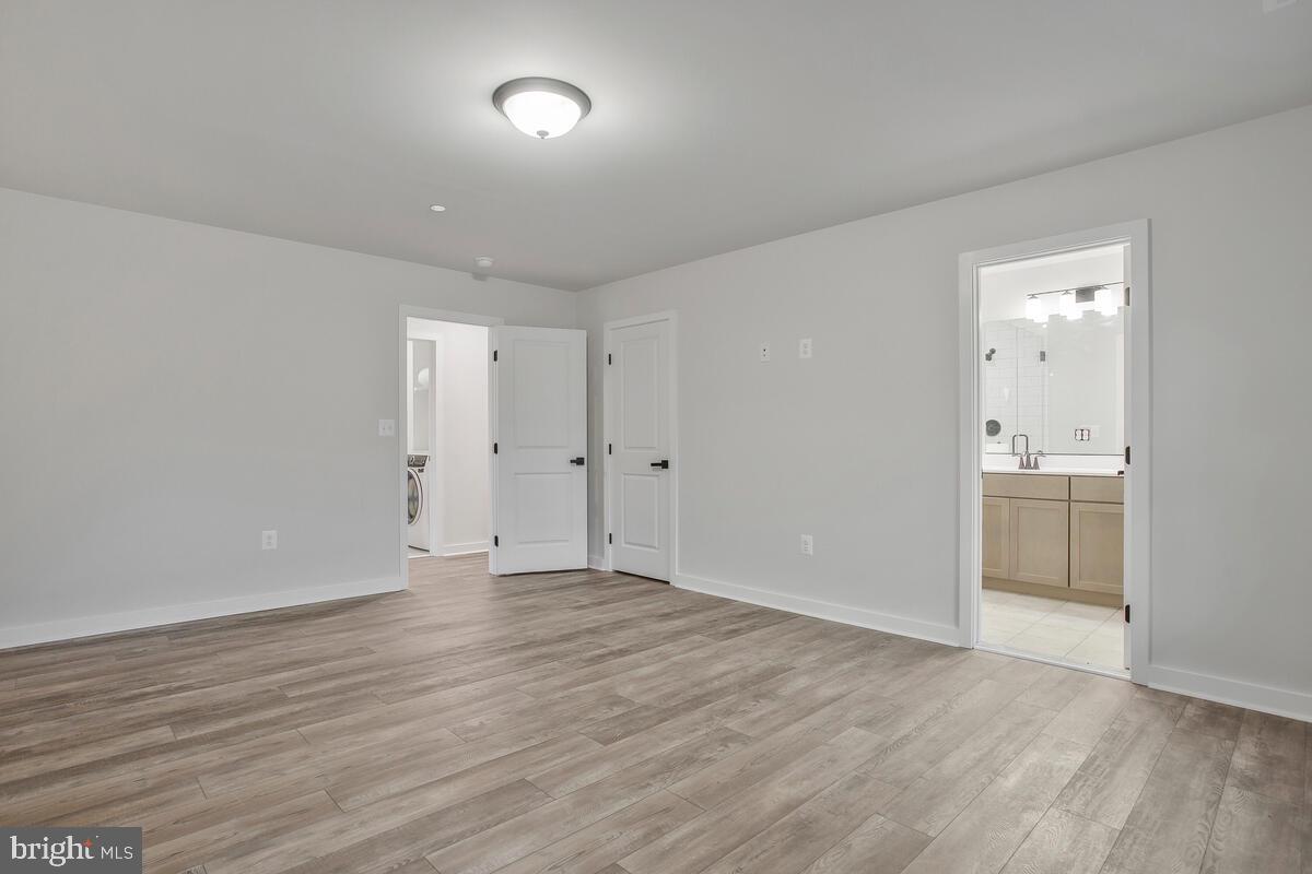 1209 Johnson Drive Shady Side, MD 20764 - Photo 14 of 37 a view of a room with wooden floor and white walls