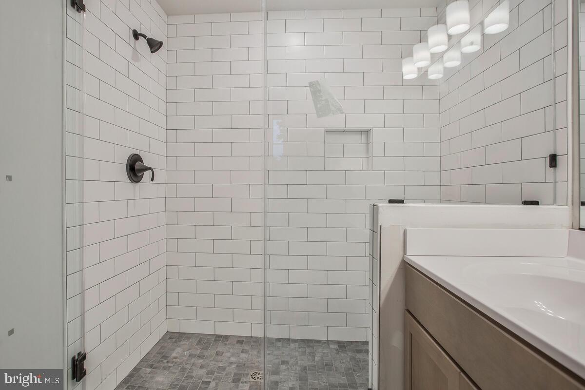 1209 Johnson Drive Shady Side, MD 20764 - Photo 15 of 37 a bathroom with a sink a toilet and shower