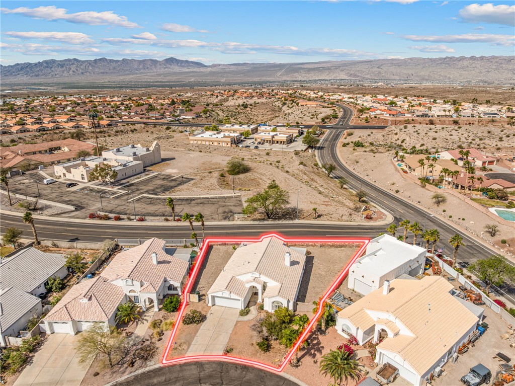 2853 Winchester Road Bullhead City, AZ 86442 - Photo 30 of 40 Aerial view showcasing the property with a red boundary outline, featuring a paved driveway and a well-maintained roof
