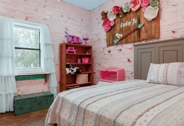 a bedroom with a bed and a dresser