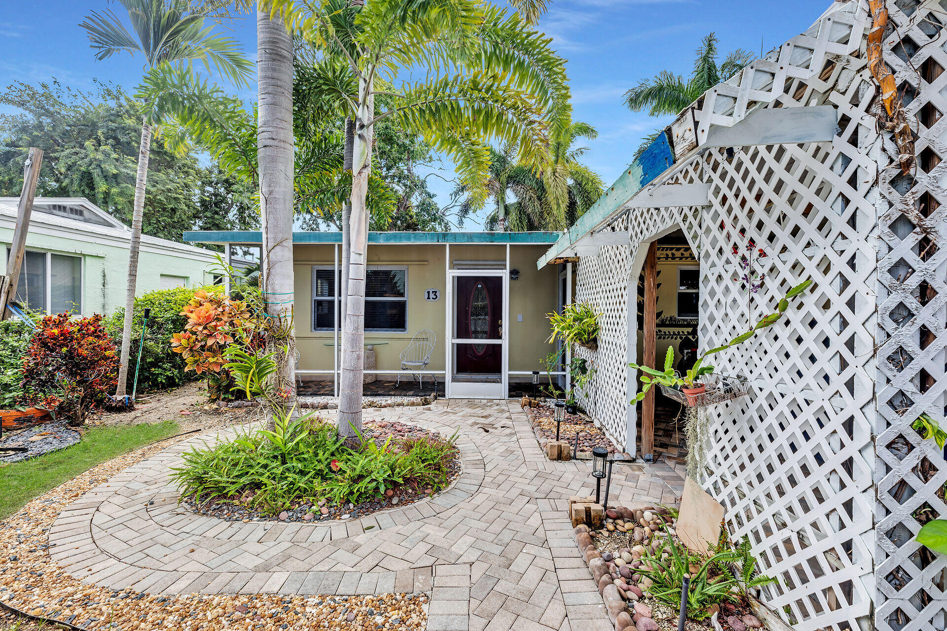 13 Bass Avenue Key Largo, FL 33037 - Photo 4 of 43 front view of house with a chairs and table in a patio