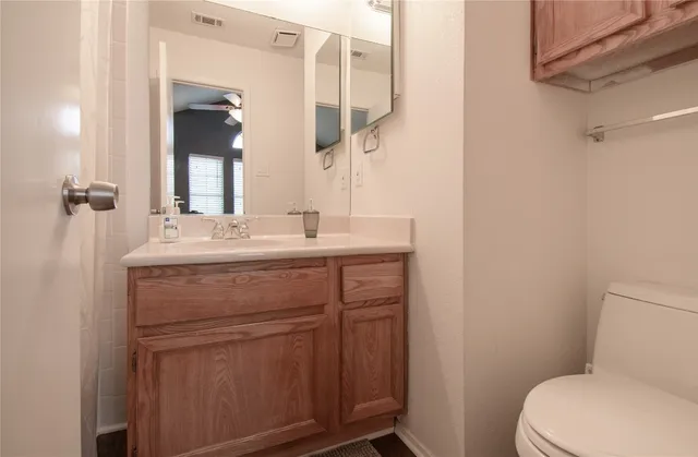 a bathroom with a sink a toilet a mirror and shower